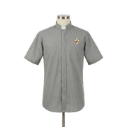 Gray clerical shirt with a cross emblem on a mannequin against a white background